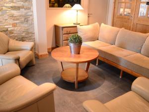 a living room with a couch and a table at Hotel Les Terrasses in Annecy