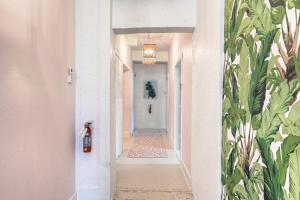 a hallway of a house with a white corridor at The Oleander Hotel Room 6 in Galveston