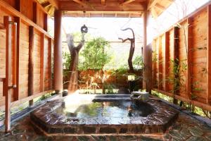 a small pond in the middle of a house at IZUNA INN & SPA - the veggie delights in Ito