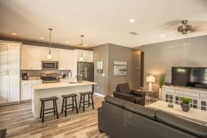 a kitchen and living room with a couch and a table at Beach Daze in Panama City Beach