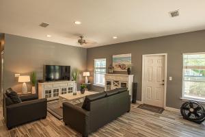 a living room with a couch and a tv at Beach Daze in Panama City Beach