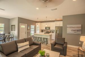 a living room with a couch and a kitchen at Beach Daze in Panama City Beach