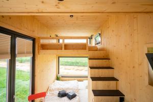 una casa pequeña con una escalera en el medio en Tiny House Nature 14 Zur Meerseite - Green Tiny Village Harlesiel, en Carolinensiel