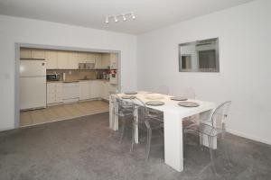 a kitchen with a white table and chairs at Ocean Reserve - Park View 1 Bedroom in Miami Beach