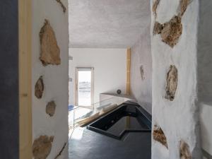 a kitchen with a stone wall and a sink at Alma Calma Hotel Rural in Tindaya