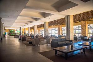 a lobby with couches and tables in a building at Gran Hotel Stella Maris Urban Resort & Conventions in Salvador