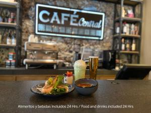 a table with a plate of food and a drink at Zocalo Central & Rooftop Mexico City in Mexico City