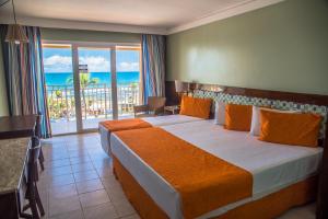 a bedroom with a bed with a view of the ocean at Gran Hotel Stella Maris Urban Resort & Conventions in Salvador