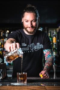 a man is making a drink at a bar at Plaza Hotel & Casino in Las Vegas