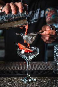 a bartender pouring a cocktail into a martini glass at Plaza Hotel & Casino in Las Vegas