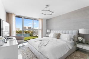 a white bedroom with a large bed and a desk at Bay Harbor One Vacation in Miami Beach