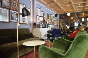 a living room with couches and chairs and a table at Browns Central Hotel in Lisbon