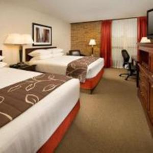 A bed or beds in a room at Hotel Lotus Kansas City Merriam