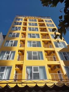 - un bâtiment jaune avec balcon dans l'établissement VANDA Hotel Nha Trang, à Nha Trang