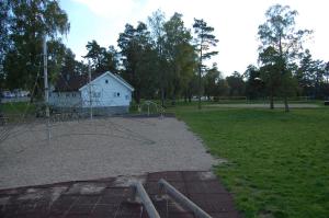 an empty park with a playground in a field at Hamresanden Resort in Kristiansand