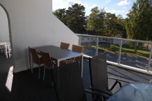 a table and chairs on a balcony with a view of a street at Hamresanden Resort in Kristiansand