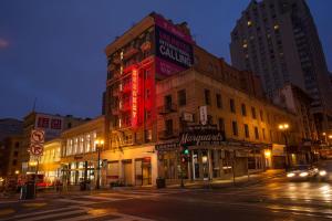 a building with a red sign on the side of a street at Herbert Hotel in San Francisco