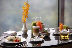 a table with two plates of food and drinks on it at Grand Fiesta Americana Chapultepec in Mexico City