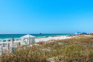 a beach with a gazebo and the ocean at Destin West Gulfside #203 in Fort Walton Beach