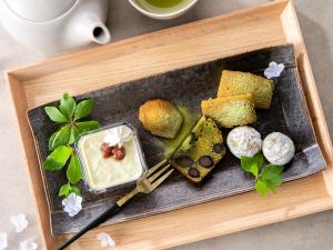 a tray of food with cakes and desserts on it at Hotel Gracery Kyoto Sanjo in Kyoto