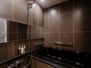 a bathroom with a sink and a shower at Hotel Gracery Kyoto Sanjo in Kyoto