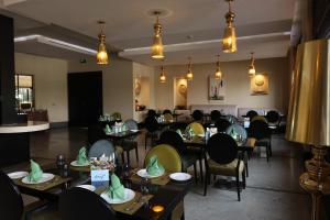 a dining room filled with tables and chairs at Safir Fintas Hotel Kuwait in Kuwait