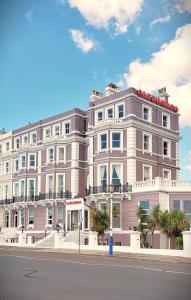 a large pink building on the side of a street at Alexandra Hotel in Eastbourne