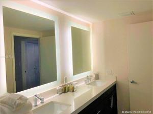 a bathroom with two sinks and a large mirror at Best Resort Beach Front Condo in Miami Beach