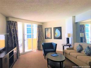 a living room with a couch and a chair and a television at Best Resort Beach Front Condo in Miami Beach