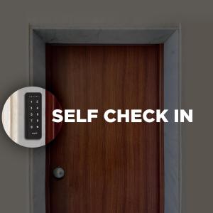 a sign on a door that reads self check in at Airport Lisbon Guest House in Lisbon