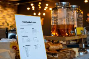 a menu on a counter with a table with bread at Staycity Aparthotels Birmingham Jewellery Quarter in Birmingham