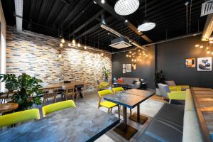 a restaurant with tables and chairs and a brick wall at Staycity Aparthotels Birmingham Jewellery Quarter in Birmingham