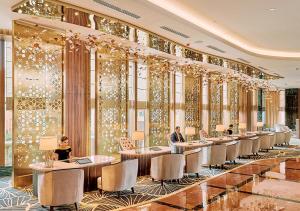 a row of tables in a hotel lobby with people sitting at them at Sunway Resort Hotel in Kuala Lumpur