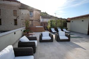 a patio with couches and chairs on a balcony at Dimora de Matera Luxury Suites in Cosenza