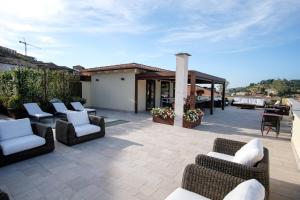 a patio with couches and chairs and a pavilion at Dimora de Matera Luxury Suites in Cosenza