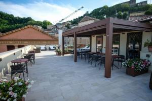 a patio with tables and chairs on a building at Dimora de Matera Luxury Suites in Cosenza