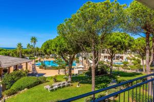 an aerial view of a resort with a pool and trees at Valentin Sancti Petri in Chiclana de la Frontera