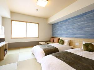 A bed or beds in a room at Onyado Nono Sendai Natural Hot Spring