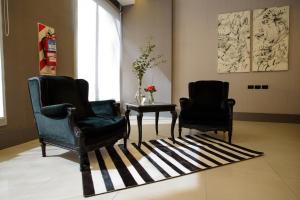 two chairs and a table in a living room at Believe Madero Hotel in Buenos Aires