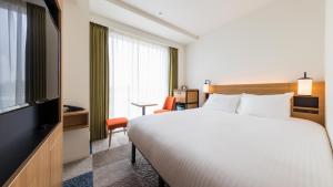 Ліжко або ліжка в номері JR East Hotel Mets Premier Yokohama Sakuragicho