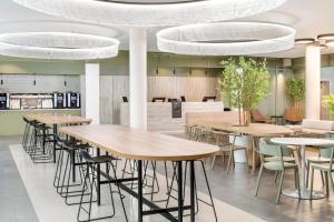 a row of tables and chairs in a restaurant at B&B HOTEL Lisboa Aeroporto in Lisbon