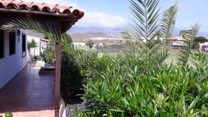 a porch of a house with a view of the mountains at La Quinta Villas in San Miguel de Abona