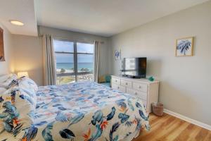 a bedroom with a bed with a view of the ocean at El Matador 454 - Beautiful views of the Gulf and pool - Includes seasonal beach service! in Fort Walton Beach