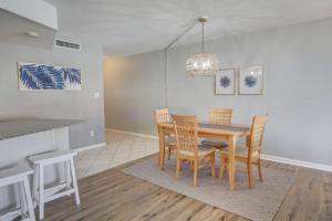 a dining room with a table and chairs at El Matador 454 - Beautiful views of the Gulf and pool - Includes seasonal beach service! in Fort Walton Beach