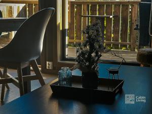 a black table with a vase and a plant on it at Apartment with Electric car charger ski in out in Sjusjøen