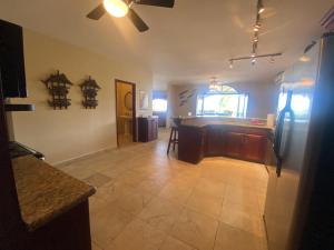 a kitchen with a island in the middle of a room at Los Porticos in Placencia Village