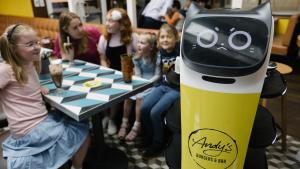 a robot standing in front of a chessboard with children at SkyCity Hotel Auckland in Auckland