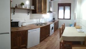 a kitchen with a sink and a stove top oven at LA QUEDADA DE NAVA in Nava del Rey