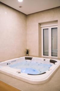 a jacuzzi tub in a room at Luxury wellness apartment SHA in Osijek