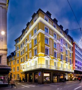 a yellow building on the corner of a street at HANNONG Hotel & Wine Bar in Strasbourg